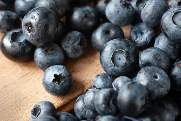 stock image Blueberry berries. Fresh blueberries on a wooden table close-up. Sprinkle blueberries. Scattered fresh blueberries. Organic food on a wooden table. Selective focus