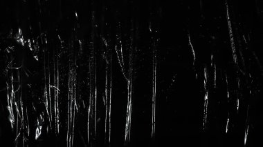 Soyut arkaplan. Polietilen parlatıcı. Siyaha sentetik parlaklık. Seçici odak