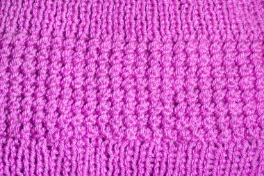 Örülmüş yüzey. Örgü kumaş dokusu. Sıcak örgü. Yün desenli. Tuhafiye yakın çekim