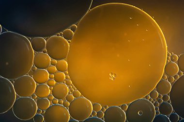 Yağ kabarcıkları. Yakından bakınca yağ kabarcıkları çıkıyor. Gri-sarı tonlarda soyut doku. Makro fotoğrafçılık