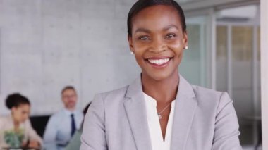 Portrait of mature beautiful black businesswoman looking at camera. Successful african american woman standing in office with satisfaction. Confident and proud woman entrepreneur smiling with copy space at conference room.