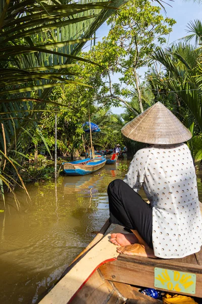 stock image Ho Chi Minh City, Vietnam- November 9, 2022:Woman with conical Vietnamese hat controls a canoe. Tourism rowing boat in the Mekong delta. Tours on Paddle boats, tourist attraction on the Mekong River