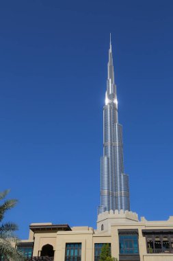 Dubai, UAE - February 14,2022: Burj Khalifa Tower in the heart of Dubai. Burj Dubai, a skyscraper in the United Arab Emirates. Known for being the world tallest building. Blue sky behind the building