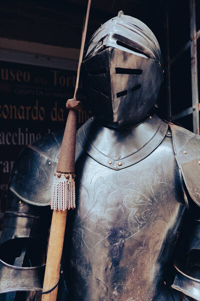 Ancient military war armor with wooden stick spear in San Gimignano