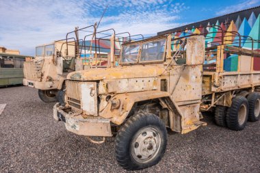 Abandoned and rusty military vehicles in the middle of the desert in Morocco