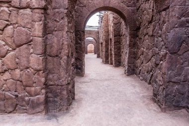 Abandoned dark stone building in the middle of the desert in Morocco