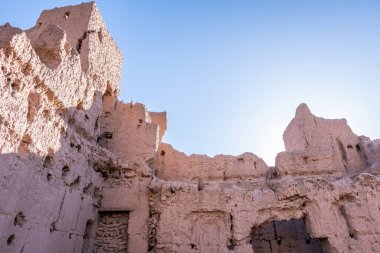 Ruins of an ancient abandoned kasbah along the road through the atlas mountains to arrive in the sahara desert in morocco