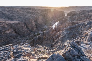 River flow in the black rocky Atlas Mountains in Morocco.