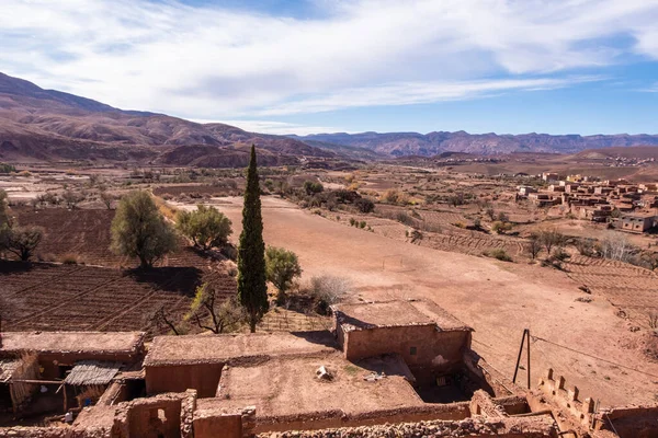 Hiking trail through idyllic beautiful lonely old clay house berber villages in high Atlas mountains valley in Morocco