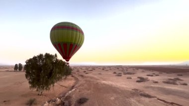 Colorful hot air balloons flying over the desert in Morocco. High-quality 4k footage