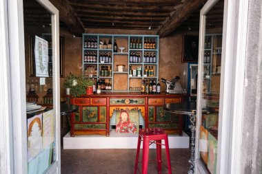 A bar seen from the street with artistic and colorful furniture in Tuscany, Italy
