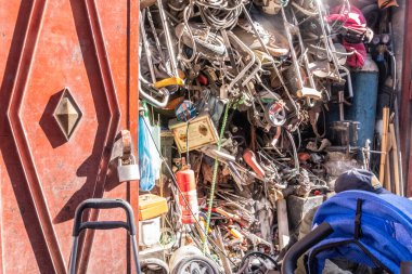 Bicycle parts and other rusty old components piled up in a souk in the Medina in Marrakech. Morocco