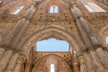 High stone walls of an abandoned medieval abbey near Siena in Tuscany, Italy