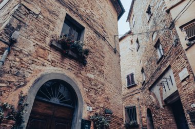 Medieval buildings in an alley of a village built in the mountains in Tuscany, Italy