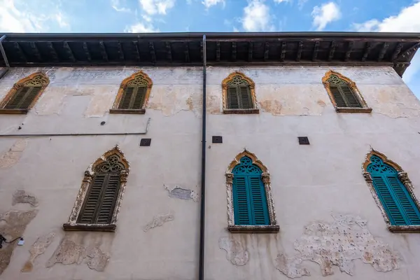 stock image Ancient palace in Verona with new and green painted windows. Italy