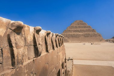 Saqqara contains the oldest complete stone building complex known in history, the Pyramid of Djoser, built during the Third Dynasty. Discover the enigmatic Snakes of Rock sculptures at Saqqara clipart