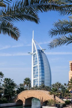 Dubai, UAE - February 23. 2023: Burj Al Arab hotel in form of a sailing boat viewed from the Souk Madinat Jumeirah. Burj Al Arab with 321 meters high is the most luxurious 7 star hotel in Dubai.