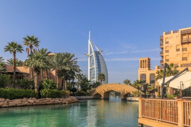 Dubai, UEA - February 23. 2023: Burj Al Arab hotel in form of a sailing boat viewed from the Souk Madinat Jumeirah. Burj Al Arab with 321 meters high is the most luxurious 7 star hotel in Dubai.