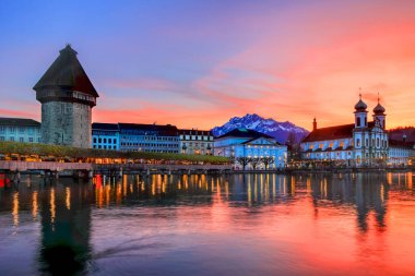 Splendid sunset over the Luzern Kappelbrucke bridge and Jesuten church with Pilatus mountain at background in the evening view, Switzerland