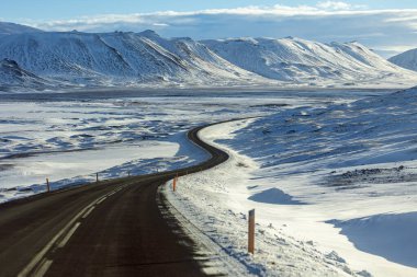 Curvy road in the highland in snow landscape, Iceland clipart