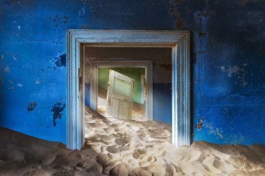 The abandoned house in Kolmanskop at sunset, deserted diamond mine village in Southern Namibia. clipart