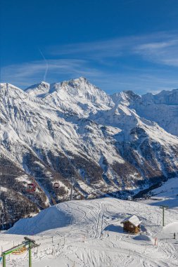 İsviçre Alpen zirvesi Weisshorn (4.505 metre) ve ayaklarının altındaki Grimentz kayak merkezi