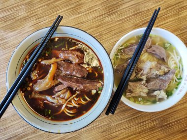 Taipei, Taiwan- 3 Dec, 2022: Braised beef noodle soup with chopsticks in Taiwan. Taiwanese beef noodle soup is a rich and comforting bowl of noodles topped with tender braised beef