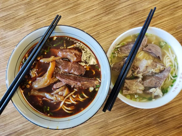 Taipei, Taiwan- 3 Dec, 2022: Braised beef noodle soup with chopsticks in Taiwan. Taiwanese beef noodle soup is a rich and comforting bowl of noodles topped with tender braised beef