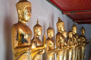 Golden Buddha statues in Wat Pho, Bangkok. Wat Pho is one of the oldest and largest temples in Bangkok features the famous Reclining Buddha