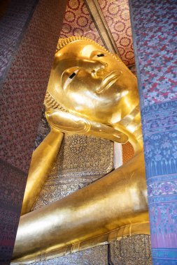 Gigantic Reclining Buddha statue in Wat Pho, Bangkok.  Wat Pho is the oldest and largest temple complex in Bangkok