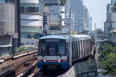 Bangkok, Thailand- 14 Feb, 2023: BTS Sky Train is running in downtown pass through skycrapers business building in Bangkok. BTS Skytrain is an elevated rapid transit system in Bangkok