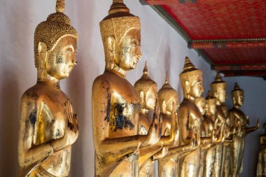 Golden Buddha statues in Wat Pho, Bangkok. Wat Pho is one of the oldest and largest temples in Bangkok features the famous Reclining Buddha