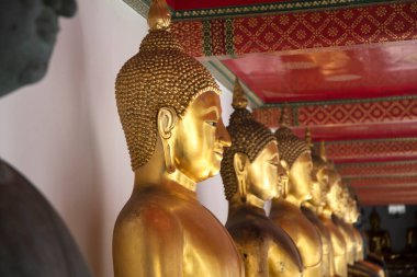 Golden Buddha statues in Wat Pho, Bangkok. Wat Pho is one of the oldest and largest temples in Bangkok features the famous Reclining Buddha