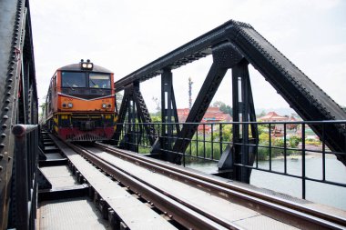 Kanchanaburi, Thailand- 16 Feb, 2023: Train on the bridge over the river Kwai Khwae in Kanchanaburi, Thailand. This bridge is famous for its history in WW2.
