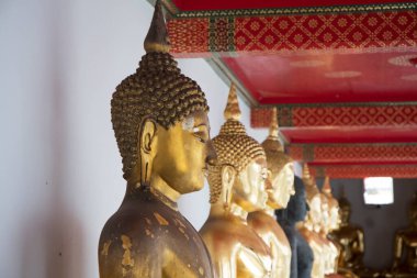 Golden Buddha statues in Wat Pho, Bangkok. Wat Pho is one of the oldest and largest temples in Bangkok features the famous Reclining Buddha