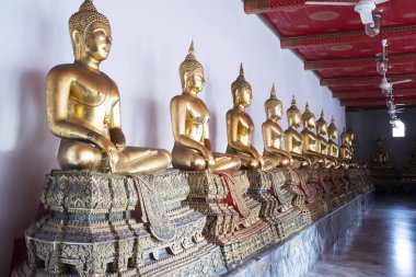 Golden Buddha statues in Wat Pho, Bangkok. Wat Pho is one of the oldest and largest temples in Bangkok features the famous Reclining Buddha