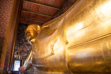 Gigantic Reclining Buddha statue in Wat Pho, Bangkok.  Wat Pho is the oldest and largest temple complex in Bangkok