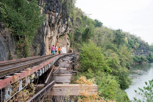 Kanchanaburi, Thailand- 16 Feb, 2023: Tourists walk along the Tham Krasae Railway Bridge, Kanchanaburi. It was built over during World-war II of only 17 days during the spring of 1943.