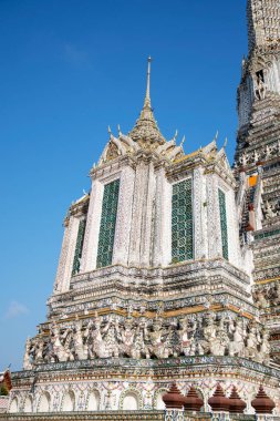 Impressive architectural details of Wat Arun (The Temple of Dawn) in Bangkok. This landmark of Wat Arun is a 70-meter-high temple tower, a stupa-like pagoda