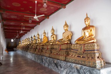 Golden Buddha statues in Wat Pho, Bangkok. Wat Pho is one of the oldest and largest temples in Bangkok features the famous Reclining Buddha