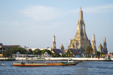 Bangkok, Thailand- 14 Feb, 2023: Wat Arun (The Temple of Dawn) and the Chao Phraya River in Bangkok, Thailand. This landmark of Wat Arun is a 70-meter-high temple tower, a stupa-like pagoda