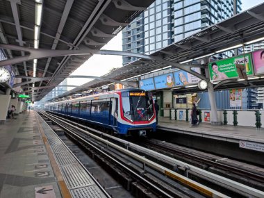 Bangkok, Thailand- 12 Feb, 2023: BTS Sky Train approaches the station platform in Bangkok. BTS Skytrain is an elevated rapid transit system in Bangkok