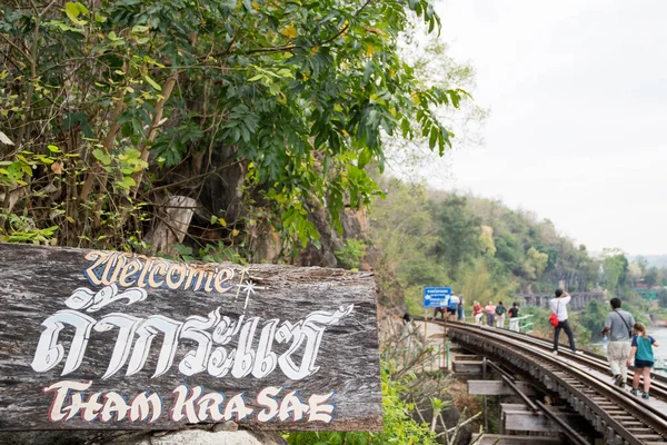 Kanchanaburi, Thailand- 16 Feb, 2023: Tourists walk along the Tham Krasae Railway Bridge, Kanchanaburi. It was built over during World-war II of only 17 days during the spring of 1943.