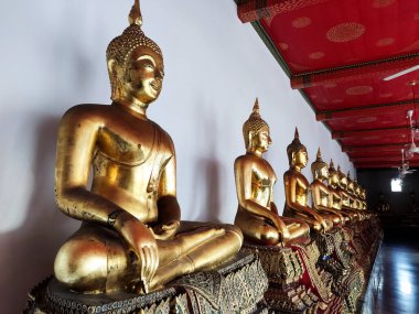 Golden Buddha statues in Wat Pho, Bangkok. Wat Pho is one of the oldest and largest temples in Bangkok features the famous Reclining Buddha
