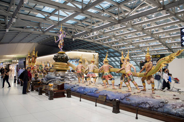 Bangkok, Thailand- 18 Feb, 2023: Scene of the Yaksha (demigod) Churning of the Milk Ocean sculpture at the duty free zone in Suvanabhumi Airport