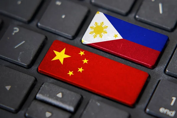 China and Philippines flags on computer keyboard. Relationship between two countries.