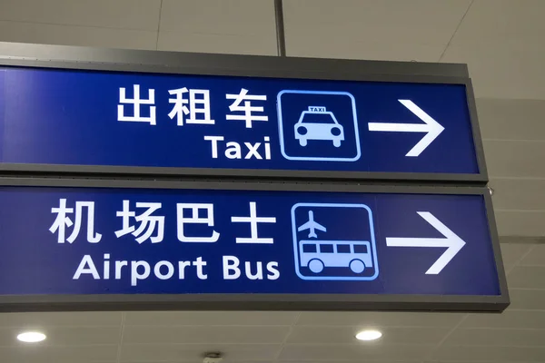 Taxi and airport bus sign hanging from ceiling in Shanghai Pudong Airport