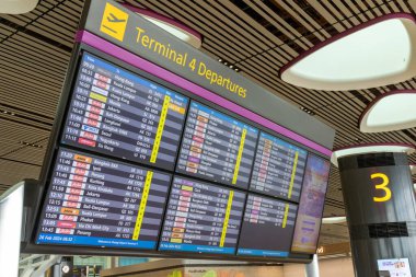 Singapur - 26 Şubat 2024: Changi Havaalanı Terminali 'ndeki kalkış salonunda ekran panosu. Terminal 4 yılda 16 milyondan fazla yolcuyla başa çıkabilecek donanıma sahip..