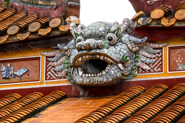 Hue, Vietnam- 28 Feb, 2024: Dragon figure on the roof of Ancestral Temple of the Founder inside the Imperial Citadel in Hue, Vietnam. The temple was badly damaged during the 1968 Tet Offensive