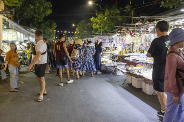 Hoi An, Vietnam- 29 Şubat 2024: Hoi An, Vietnam 'daki Nguyen Hoang Gece Pazarı' nda hediyelik eşya satıcısı. Nguyen Hoang Gece Pazarı Hoi An 'ın en ünlü pazarıdır.